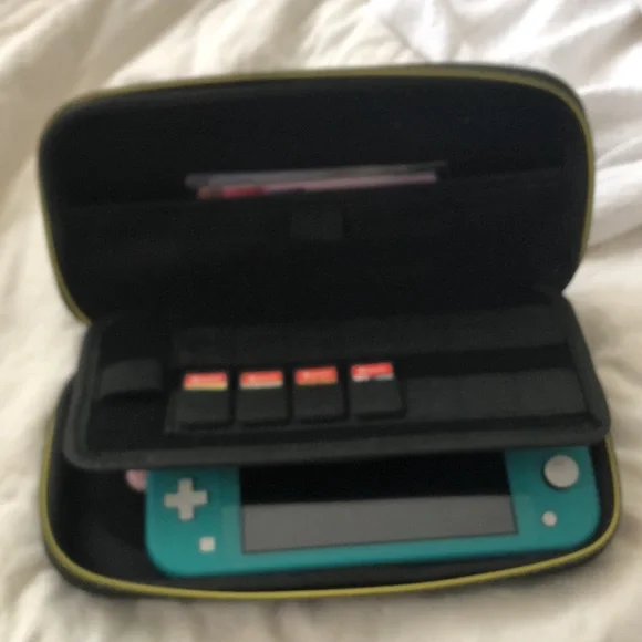 Nintendo Switch Lite with 3 games, 3 characters for Animal Crossing, and case.